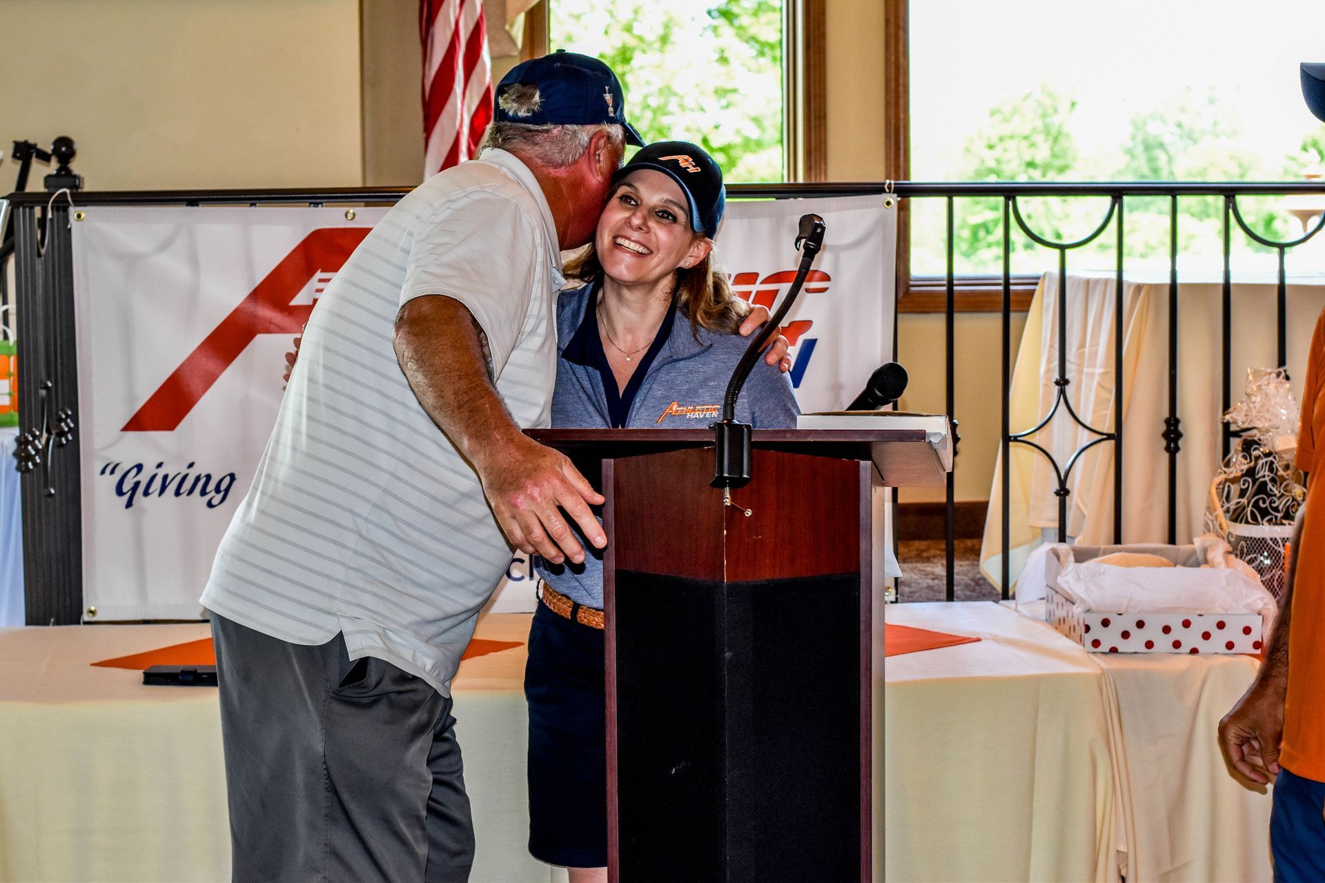 man and woman hugging at Athletic Haven banquet