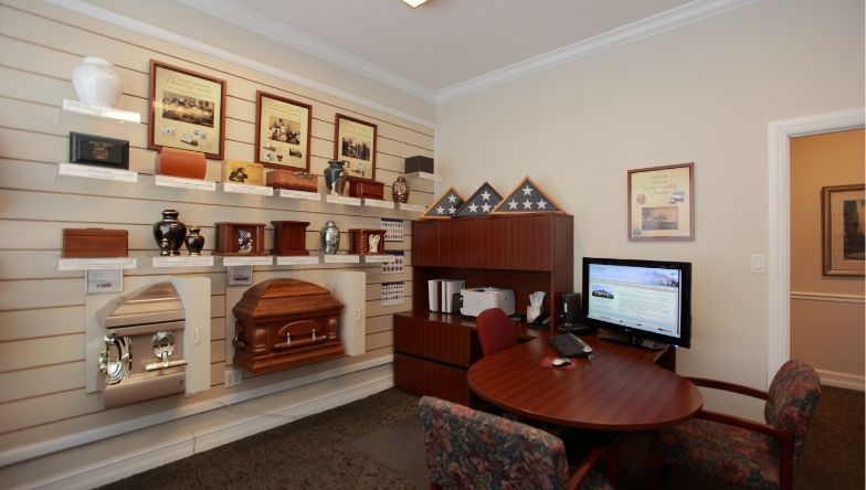 A room with a table and chairs and a computer