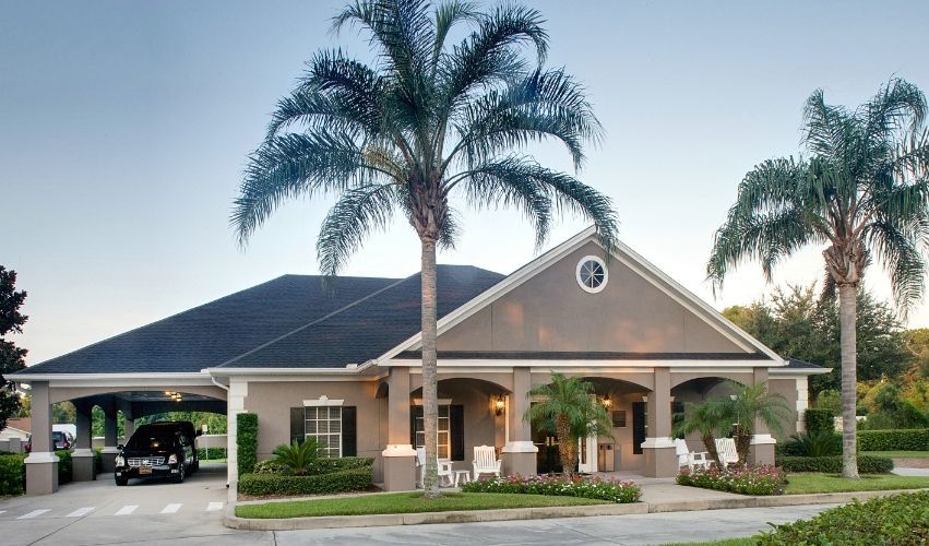 A large house with palm trees in front of it