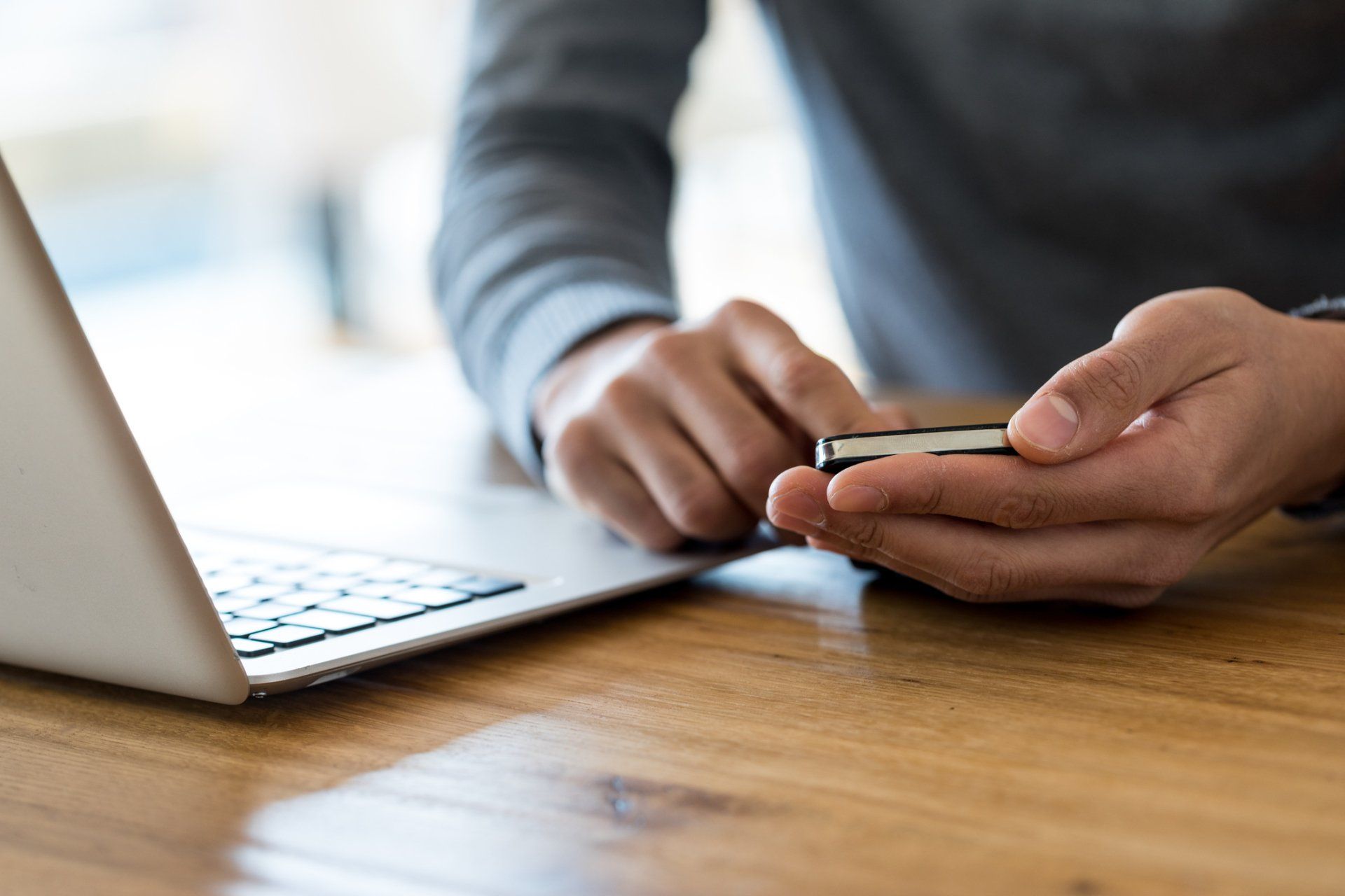 Man Using His Laptop and Phone While Working — Charlottesville, VA — William Grupp Dentistry