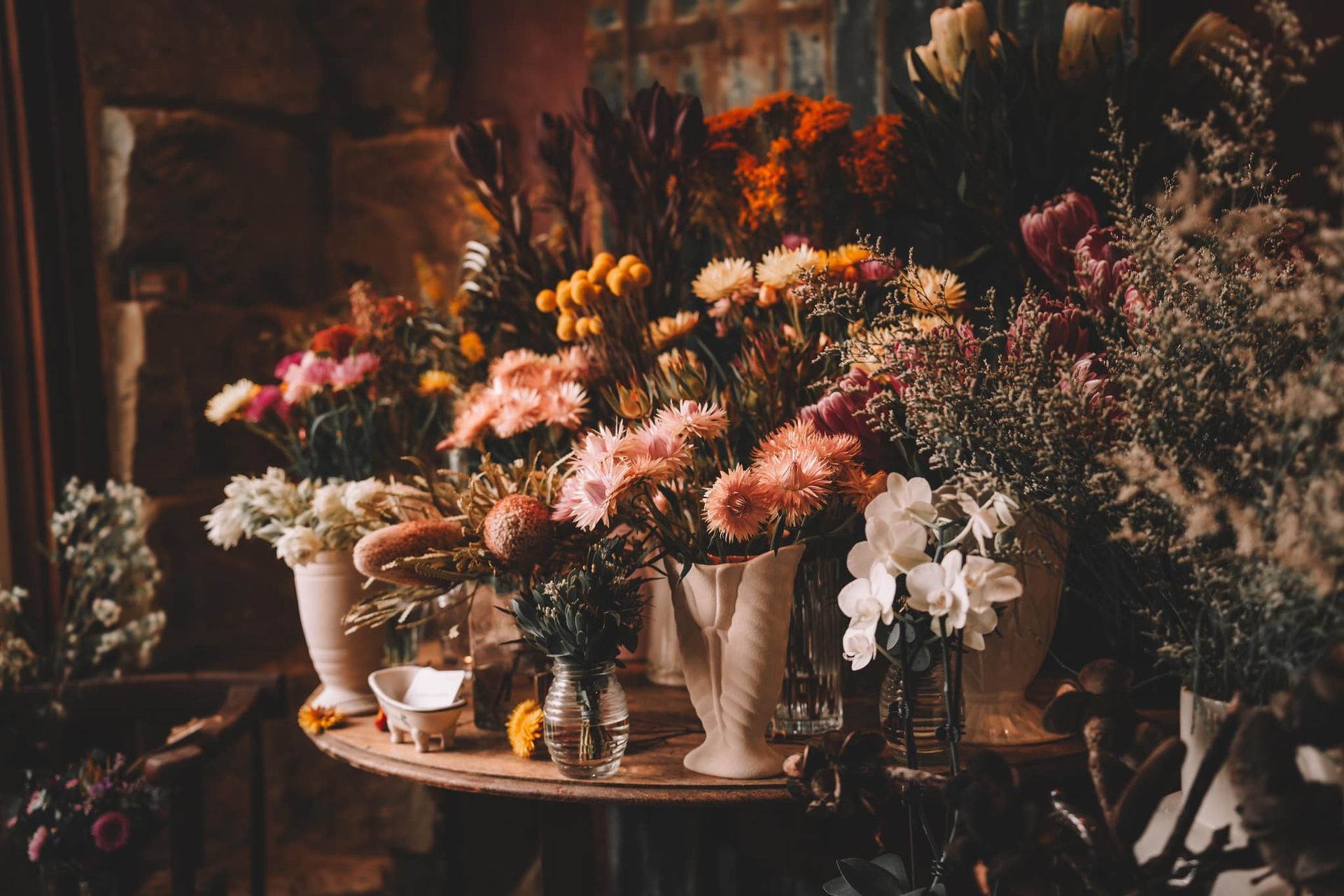 Two Bouquets of Dried Flowers Are Sitting next to some ladies heels — Flowers by Suzanne in Maitland, NSW
