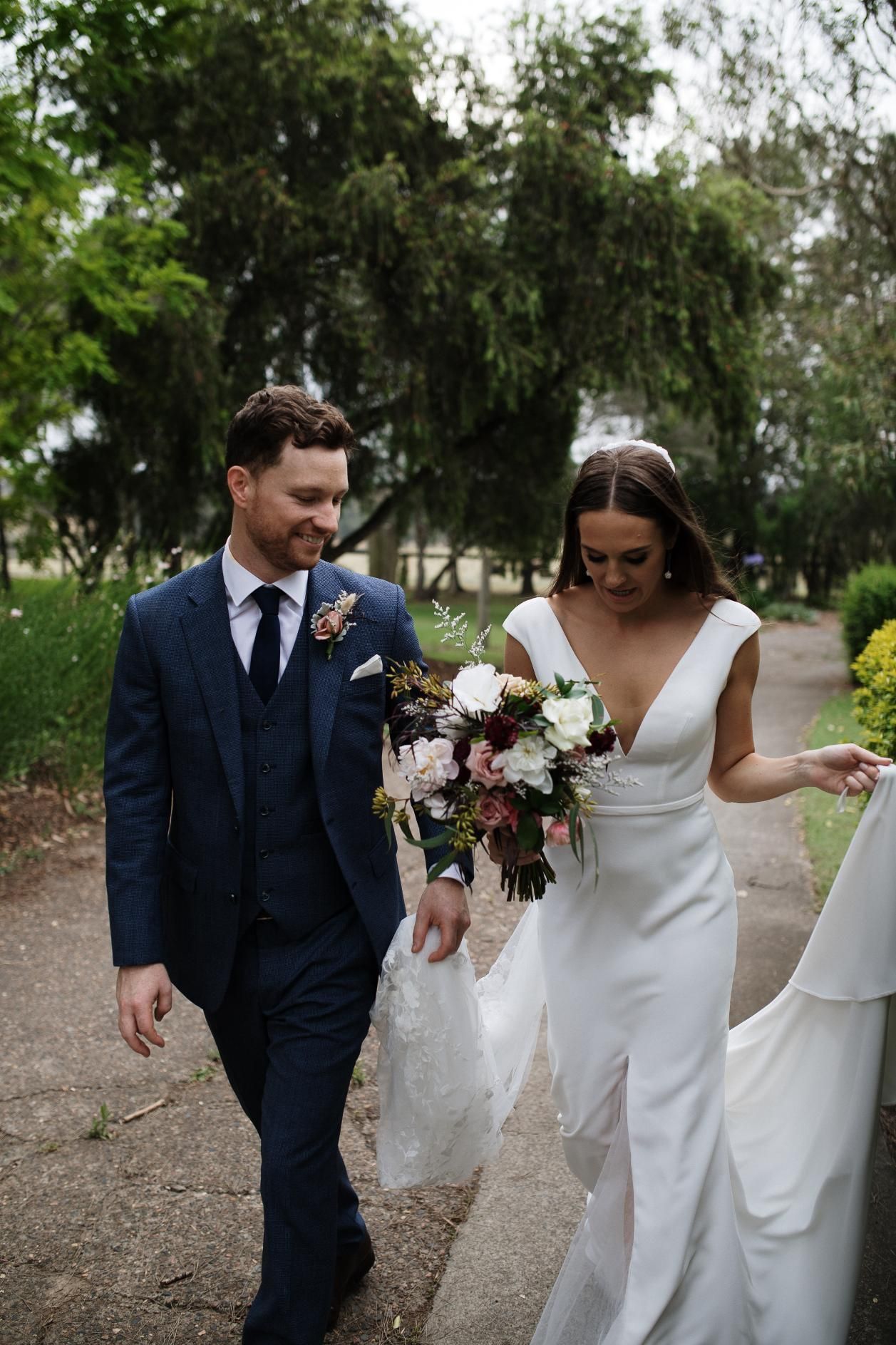 A couple outside in a park holding some wedding flowers— Flowers by Suzanne in Maitland, NSW