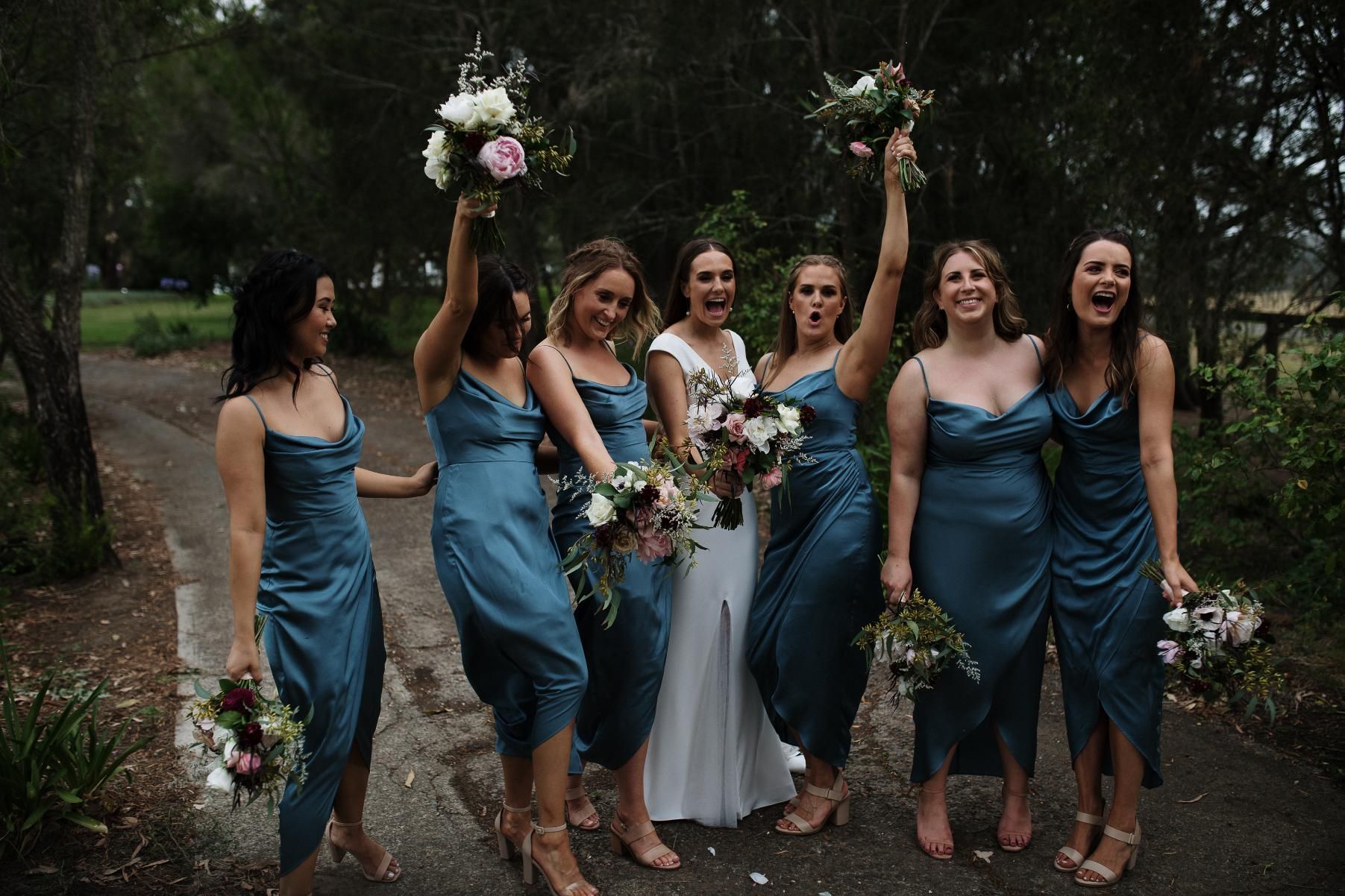 A couple outside in a park holding some wedding flowers— Flowers by Suzanne in Maitland, NSW