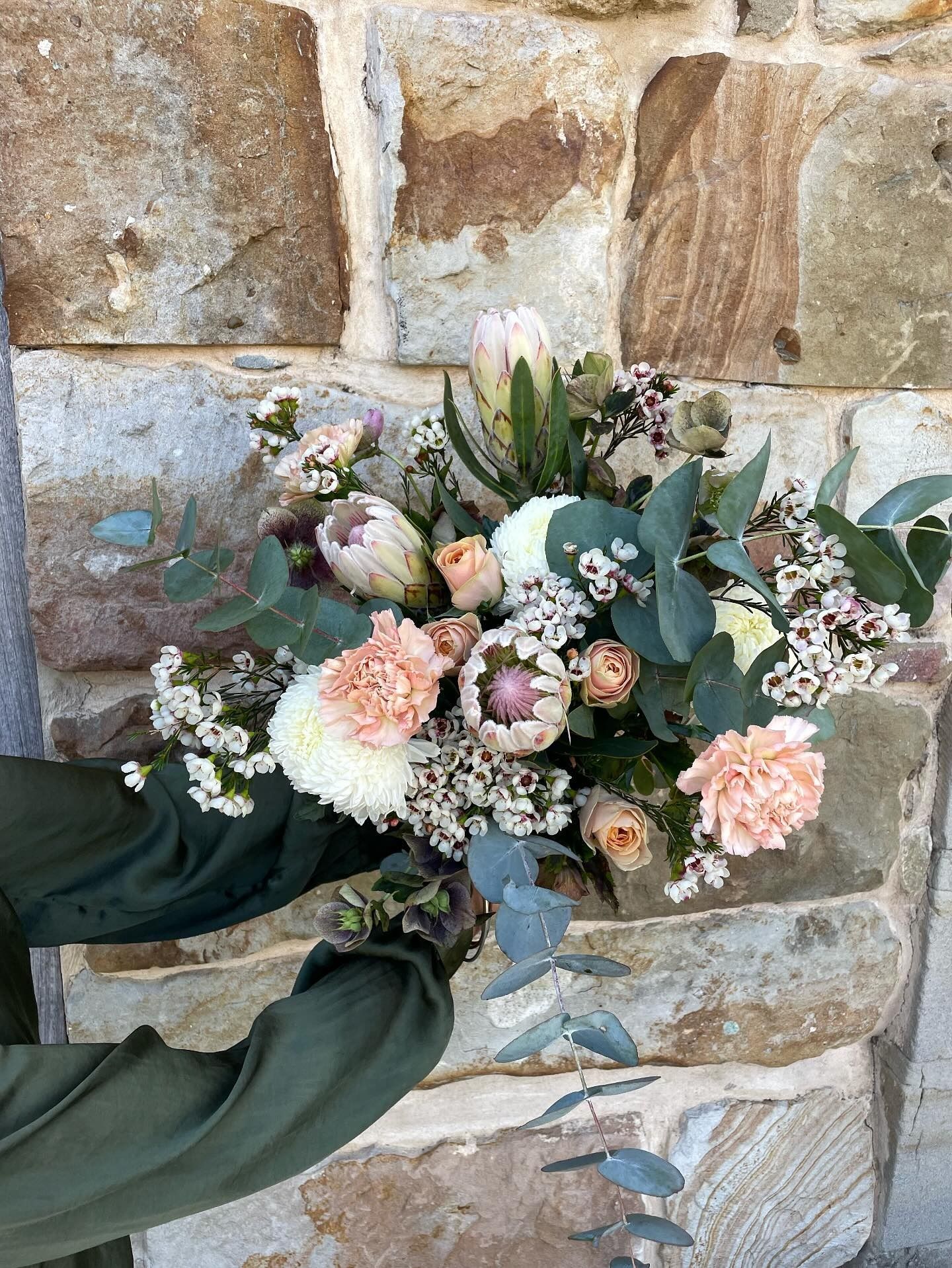 A couple outside in a park holding some wedding flowers— Flowers by Suzanne in Maitland, NSW