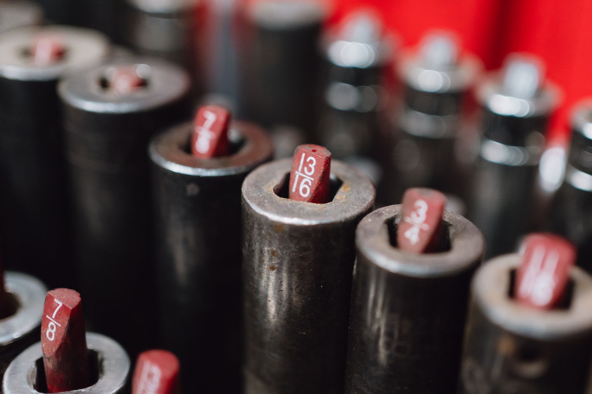 Close-up of black cylindrical cables with red numbered tags in a blurred industrial setting | Texas Hill Country Diesel and Automotive