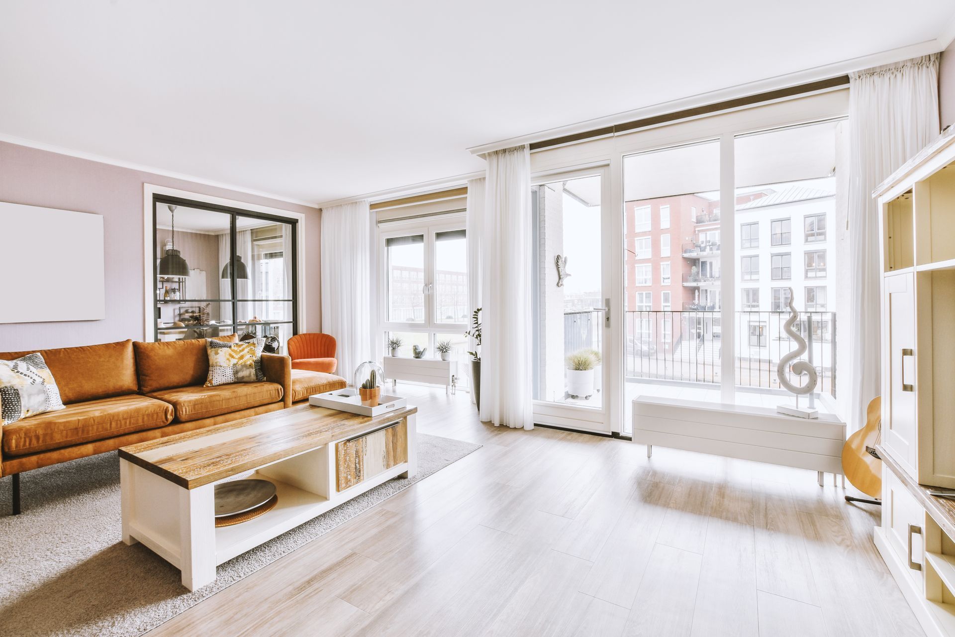 A living room with a brown couch and a white coffee table.
