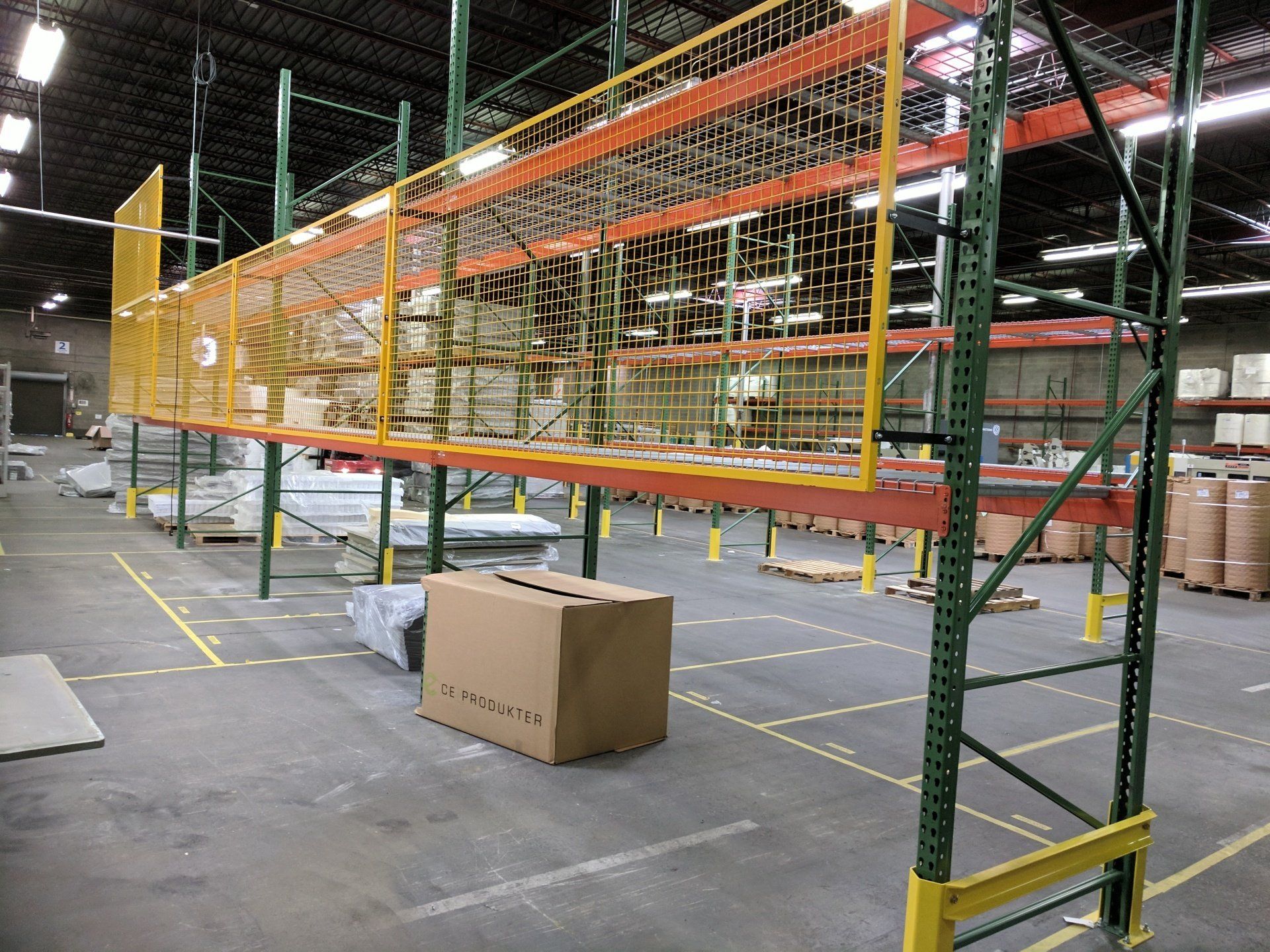Pallet rack with wire panel rack back protection to keep product from falling off the back