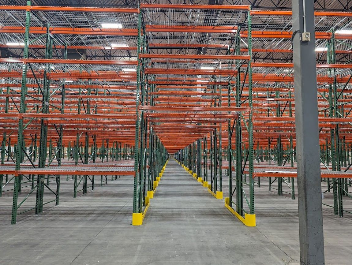 Pallet rack tunnel aisle with end guards.