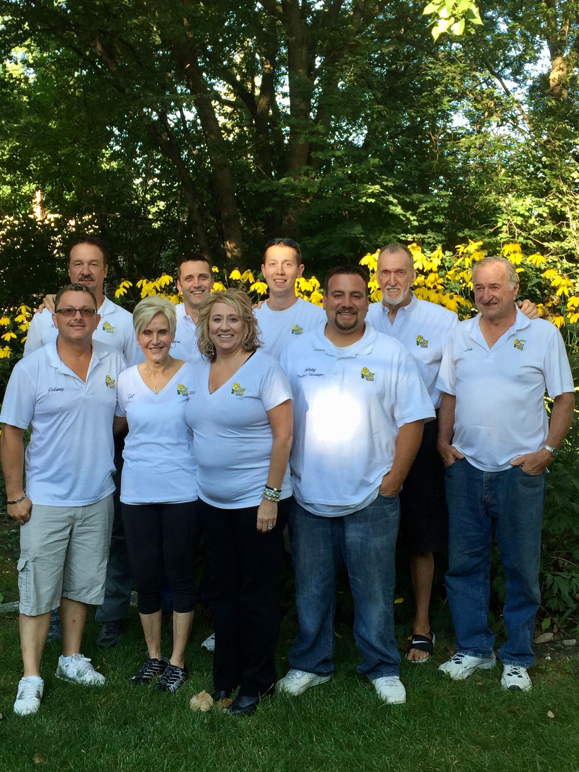 A Group of People Wearing White Shirts Are Posing for A Picture | Detroit, MI | Yellow Rose Builders