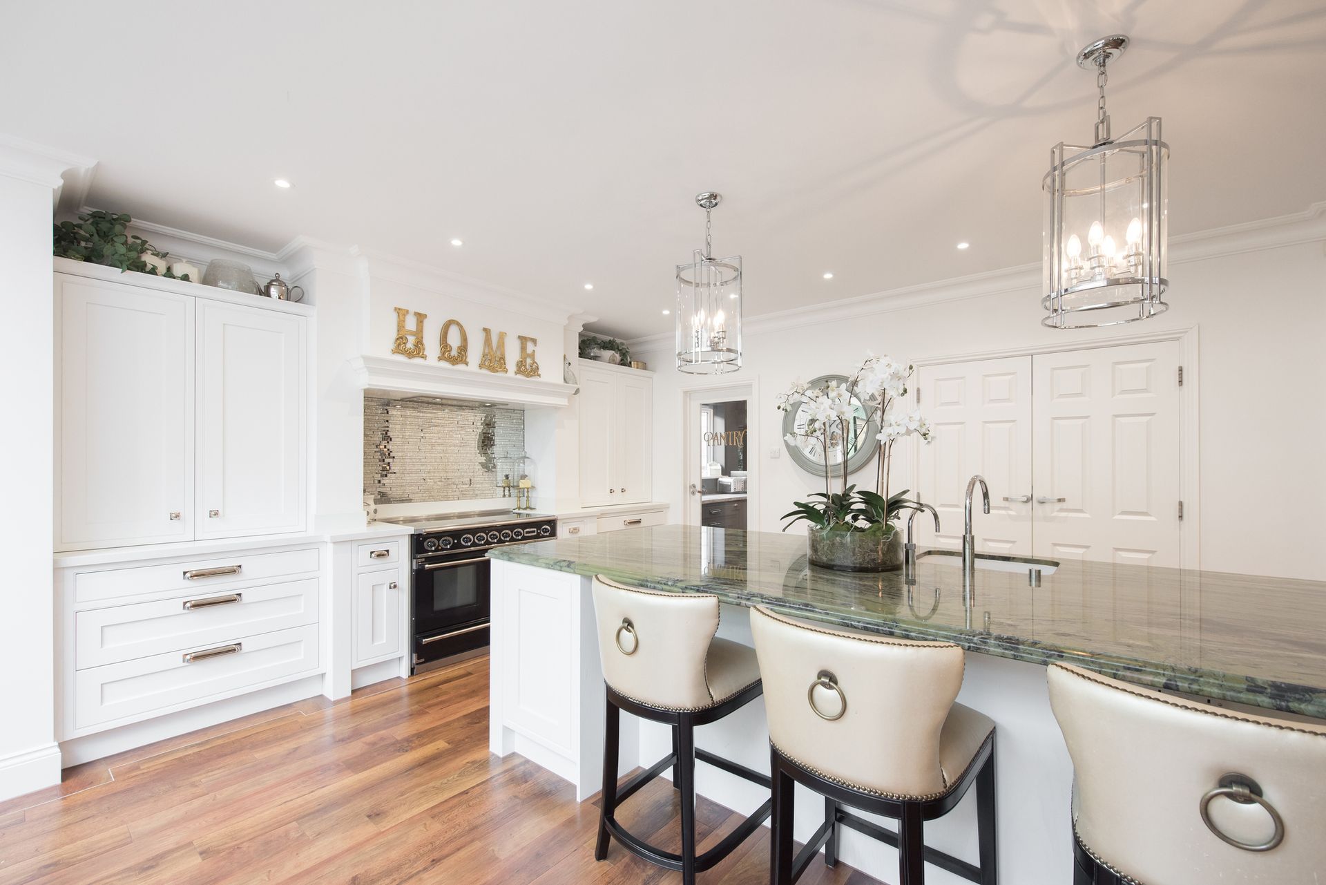 A Kitchen with A Large Island and Stools and A Sign that Says Home | Detroit, MI | Yellow Rose Builders