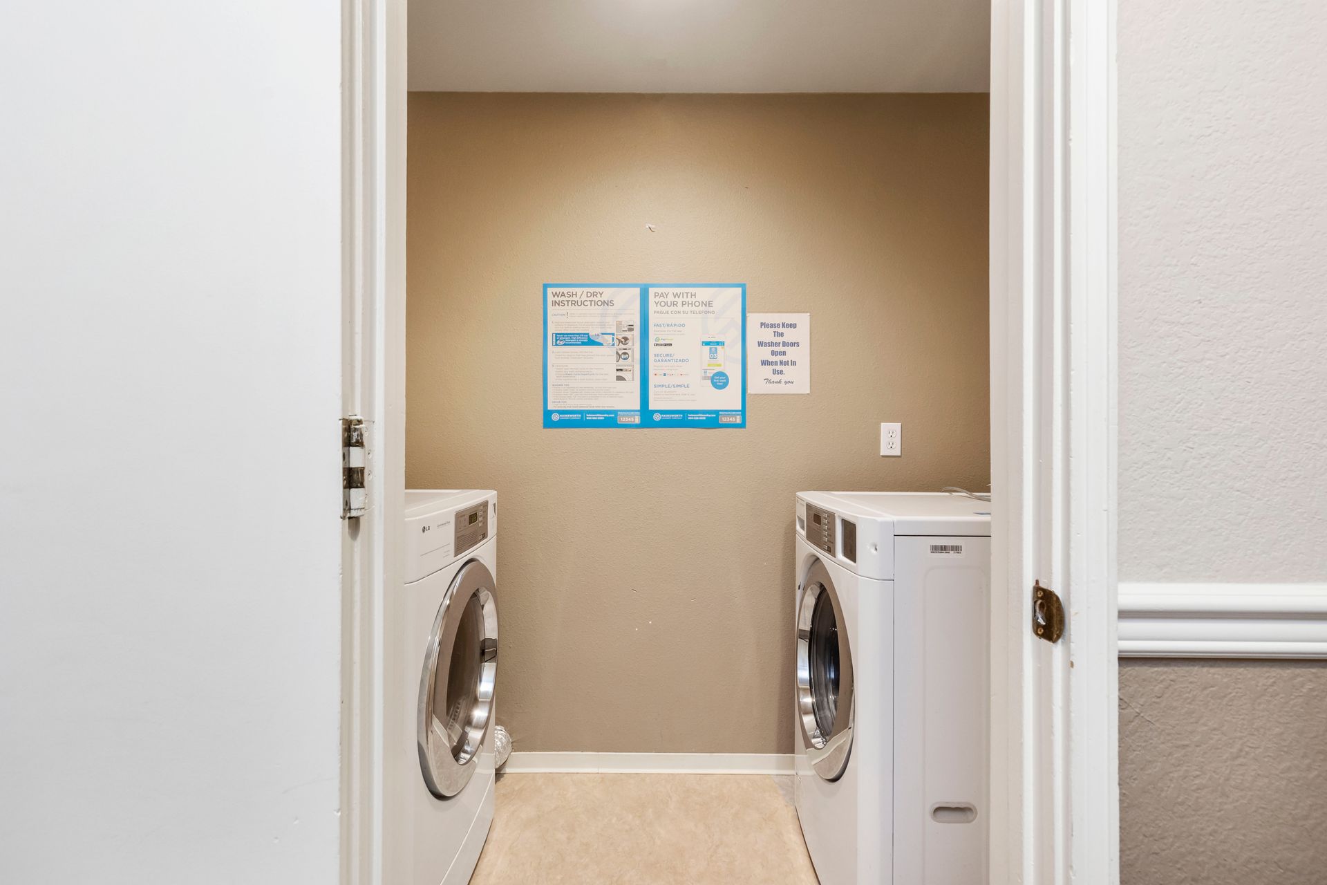 a laundry room with two washing machines and a dryer .