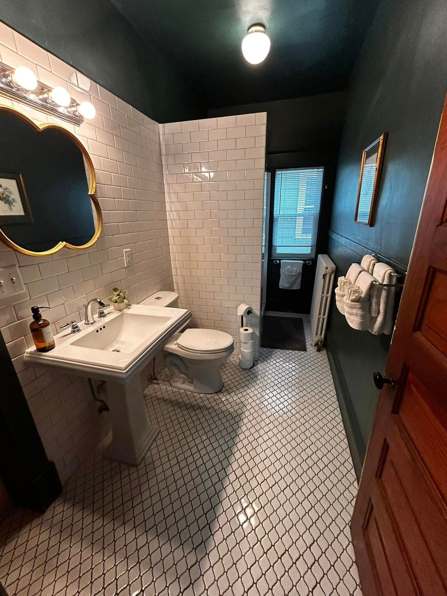 A bathroom with a sink , toilet , and mirror.