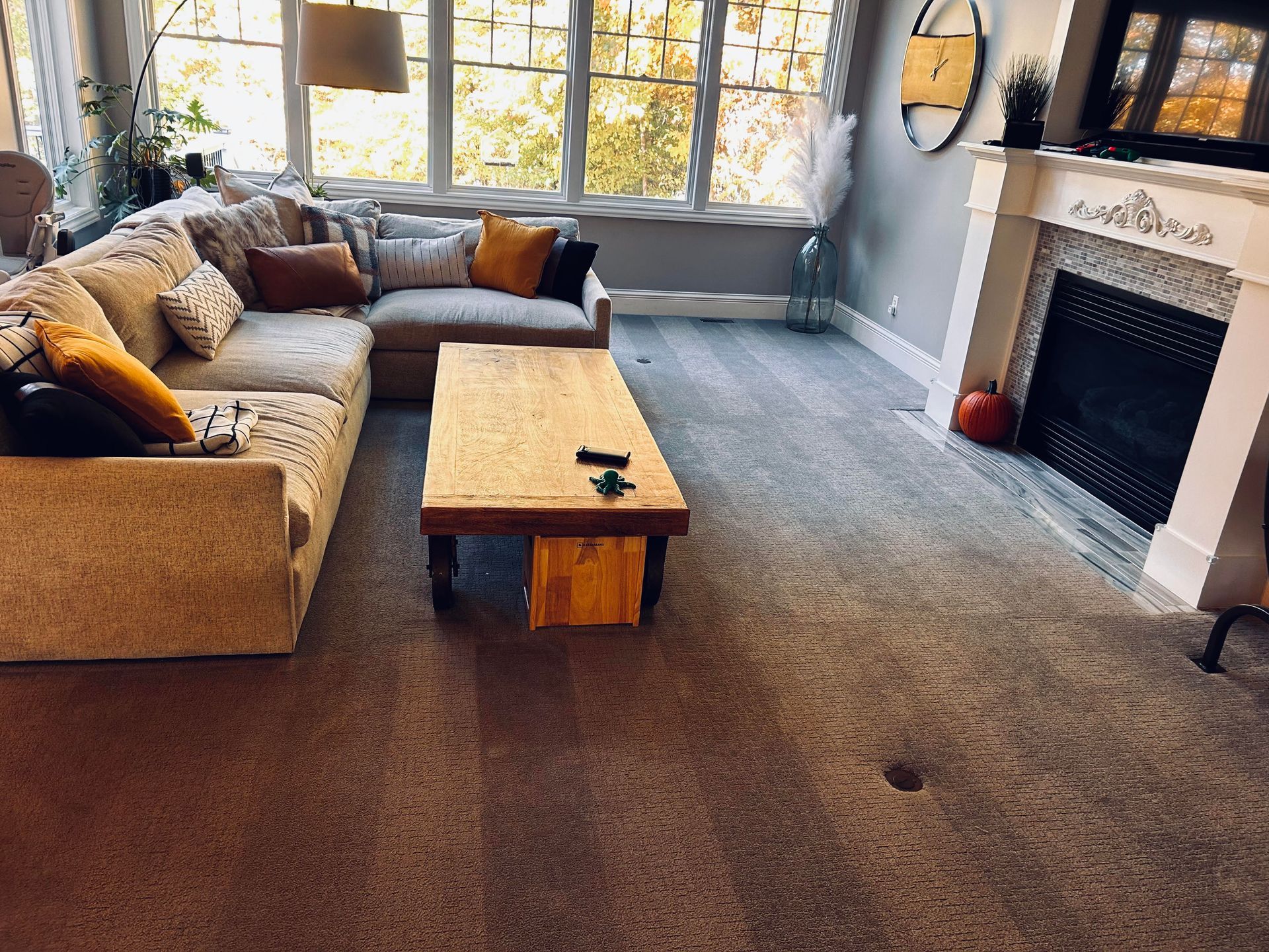 A living room with a couch , coffee table and fireplace.