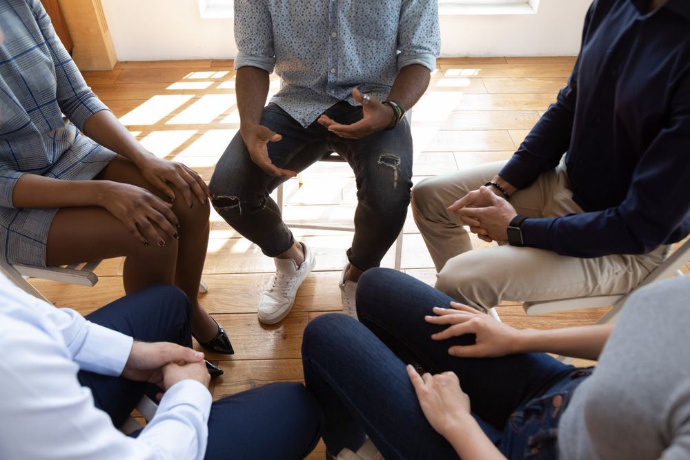 People Sitting in a Well-lit Room, Possibly a Therapy or Support Group — PoDDSS in Hyde Park, QLD