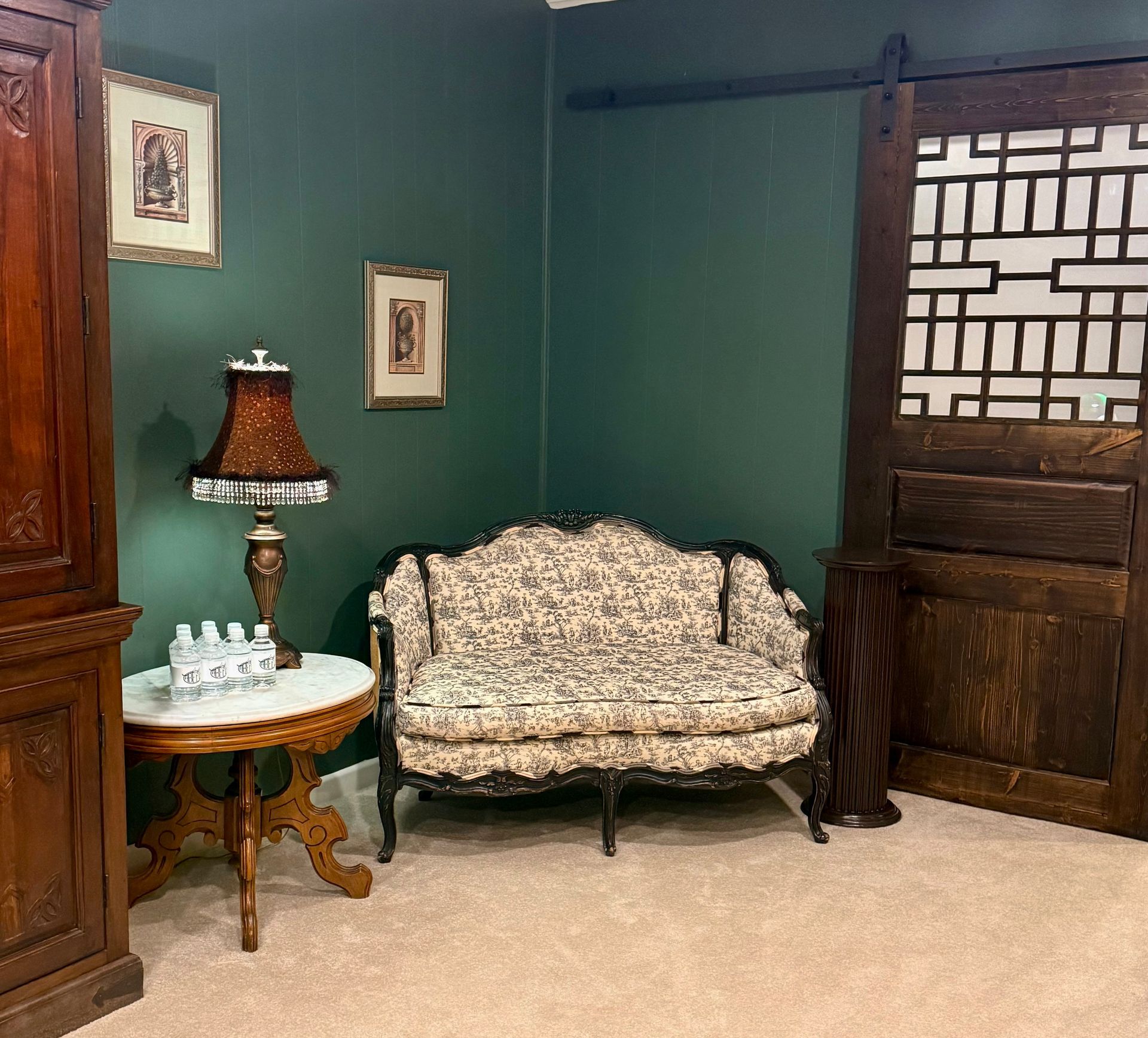 An artist 's impression of a hotel lobby with a couch , chairs , and plants.