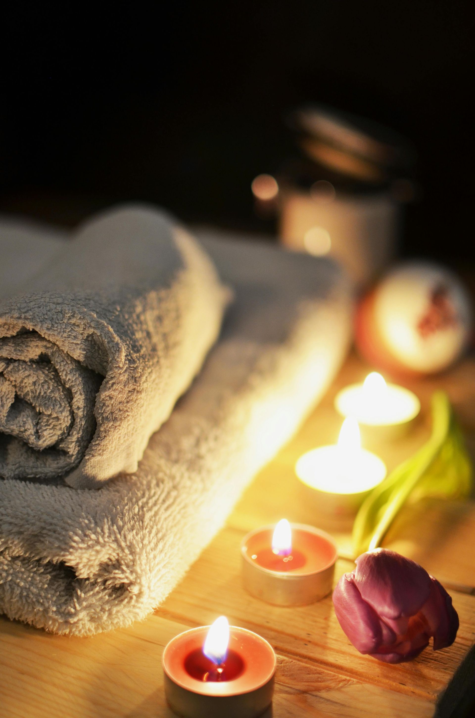 A massage table with candles and reed diffusers on it in a spa.