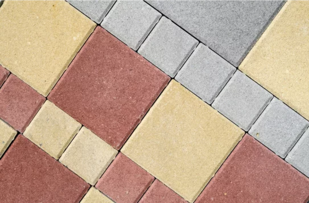 A close up of a brick floor with different colors and patterns.