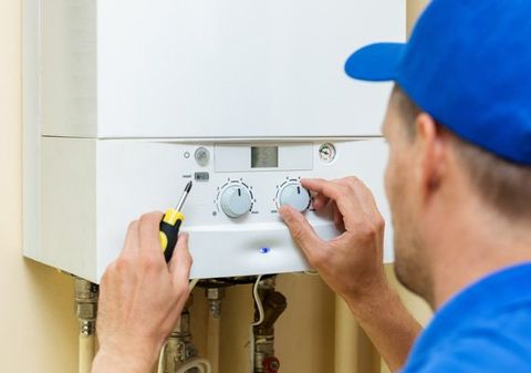 Heater Repair — Technician Repairing A Heater In Waterbury, CT