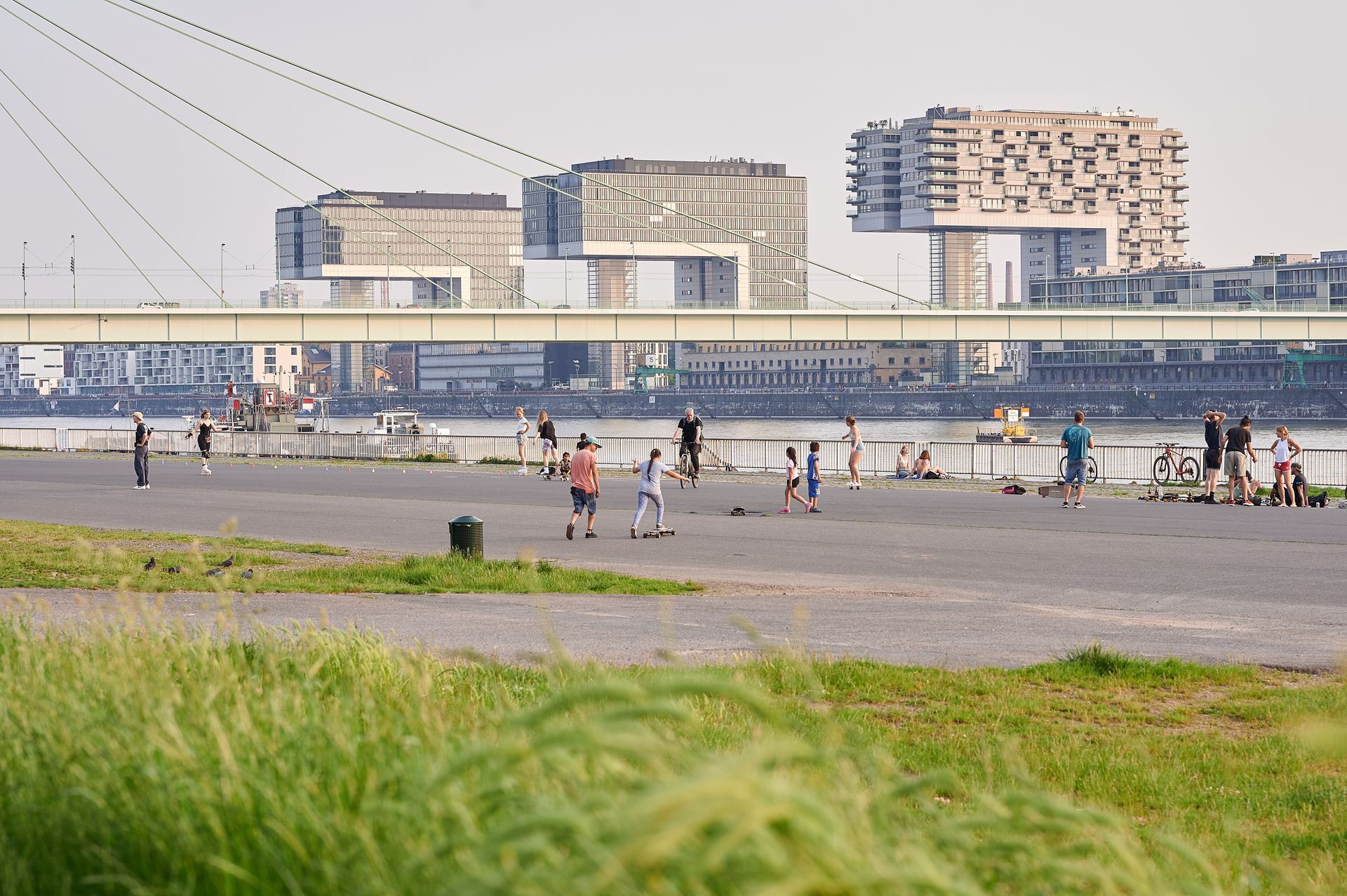 A group of people are walking across a bridge over a body of water.