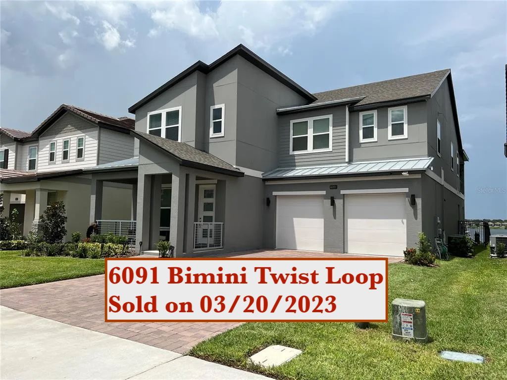 A boy and a girl are playing in a cardboard box in a living room.