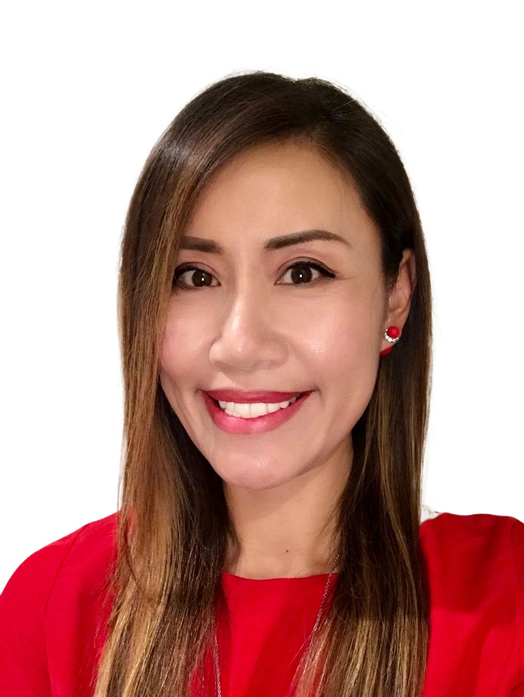 A man in a blue shirt is standing with his arms crossed and smiling.