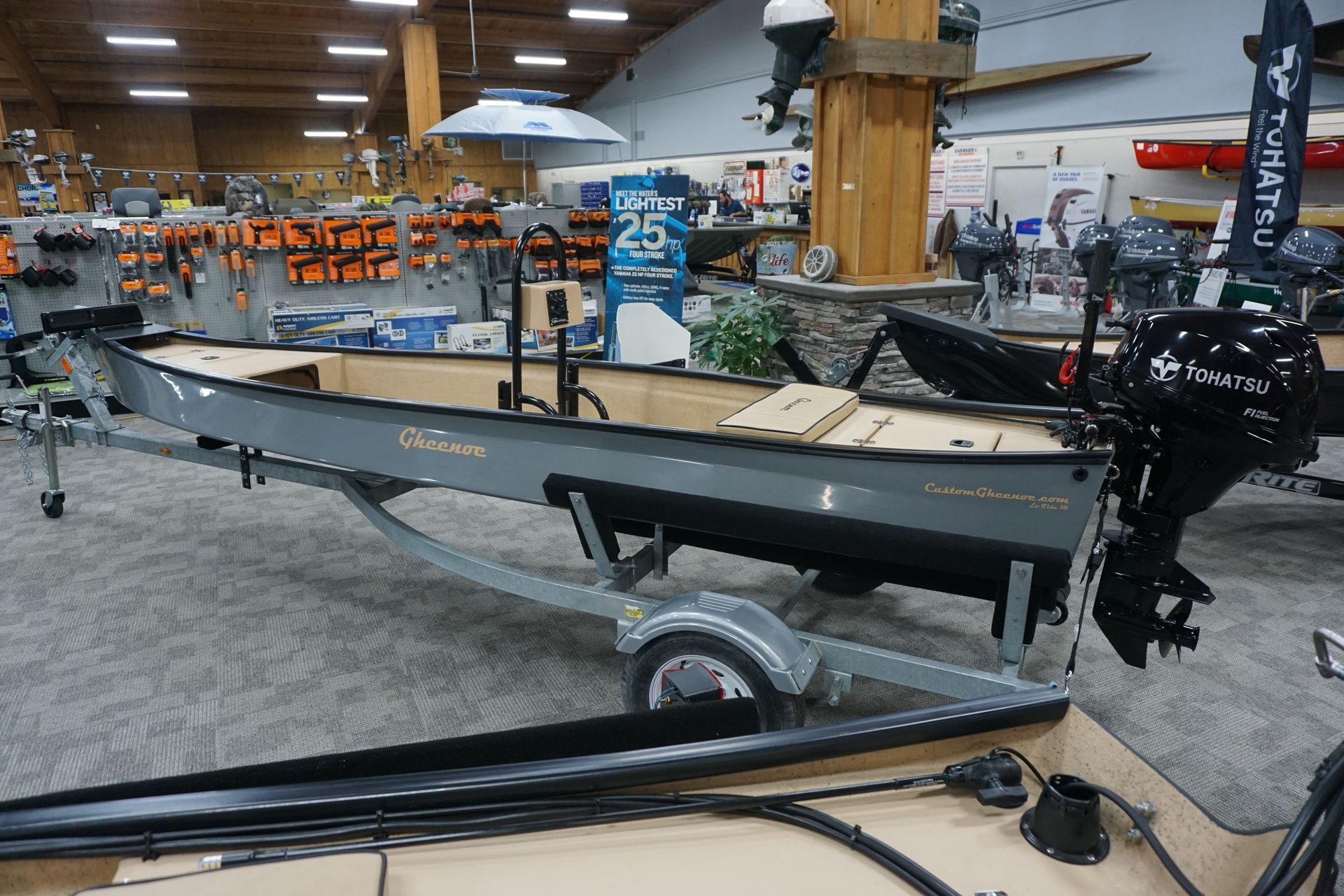 A boat is sitting on a trailer in a showroom.