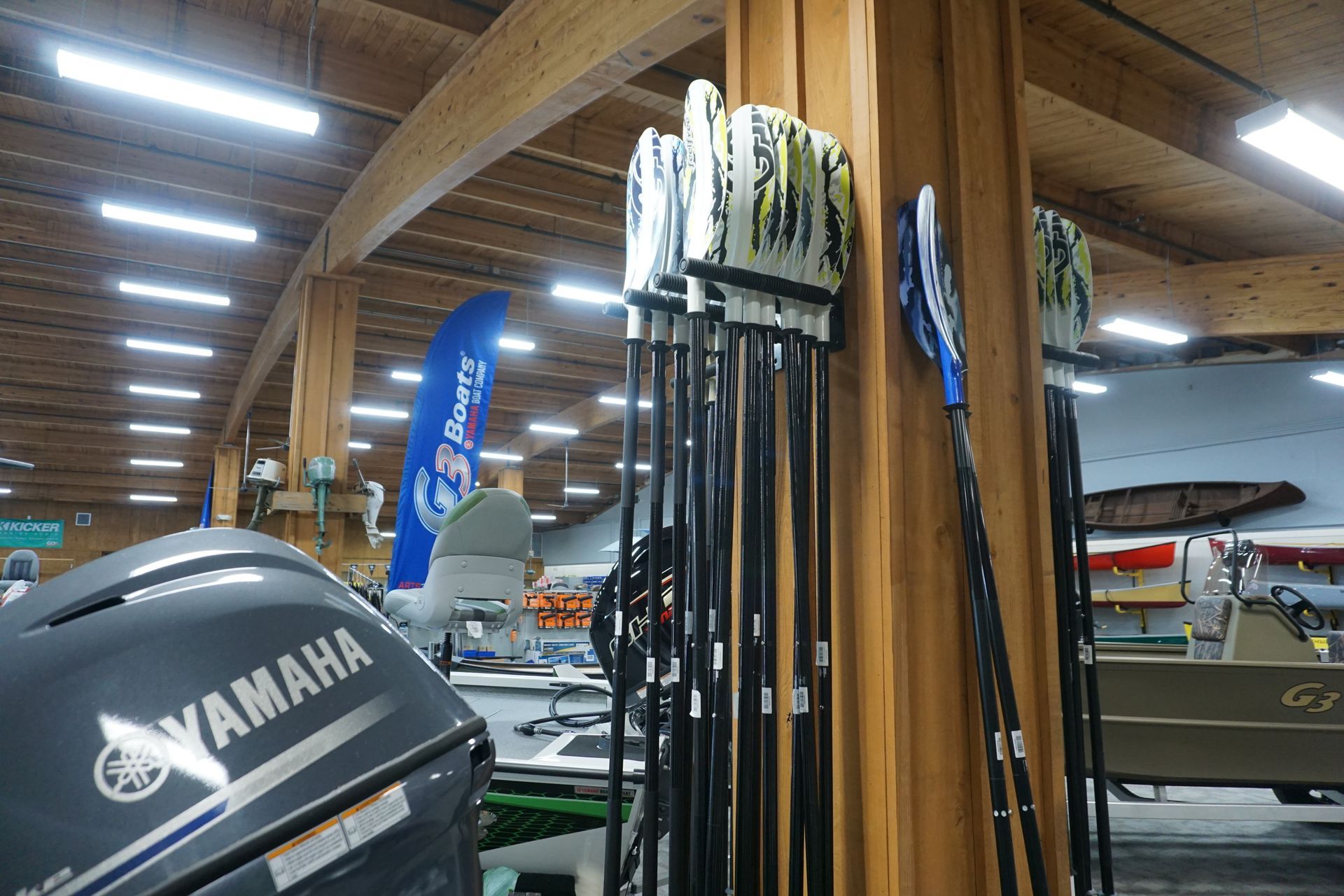 A yamaha engine is sitting next to a row of fishing rods.