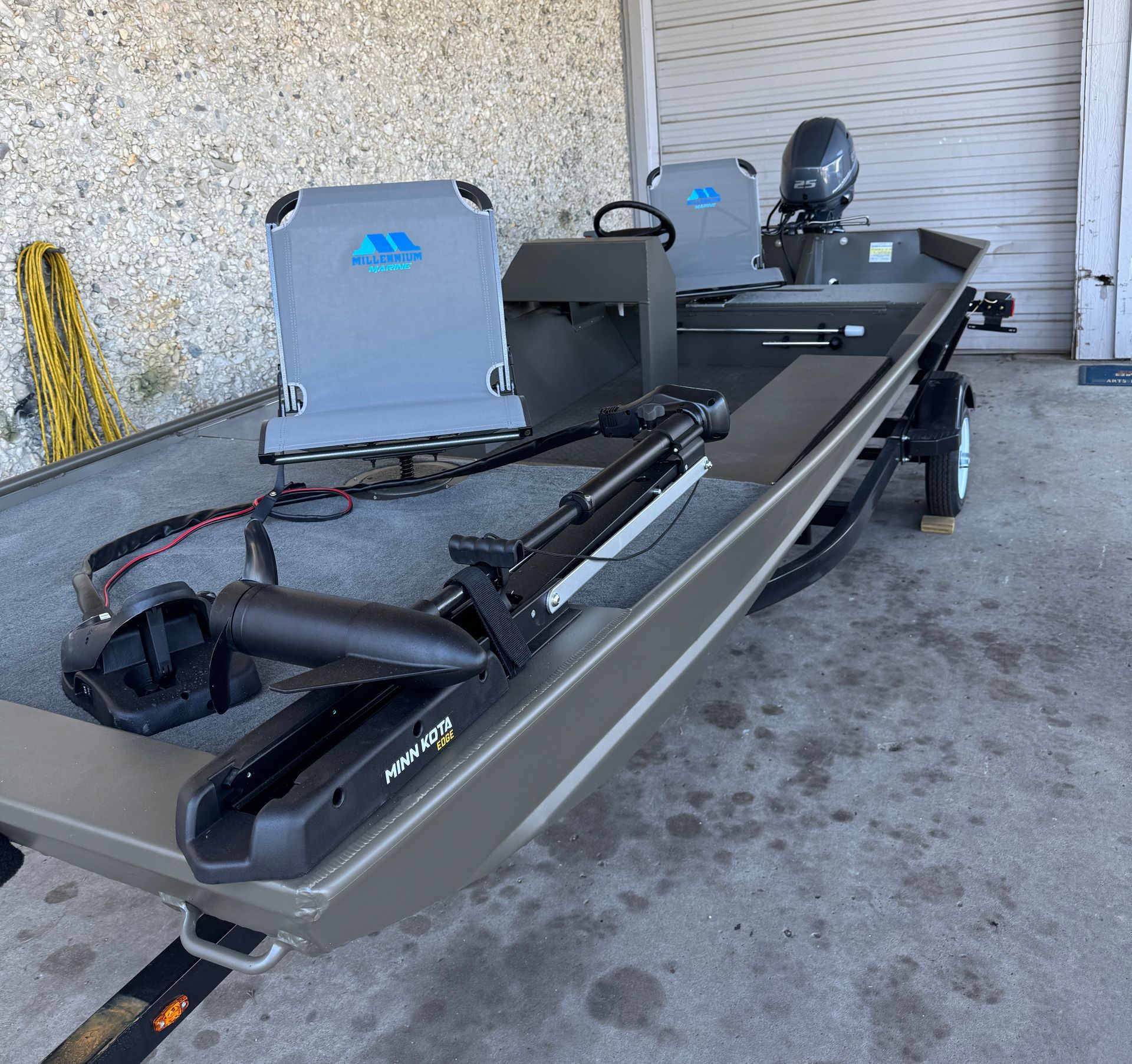 A boat with a motor attached to it is parked in a garage