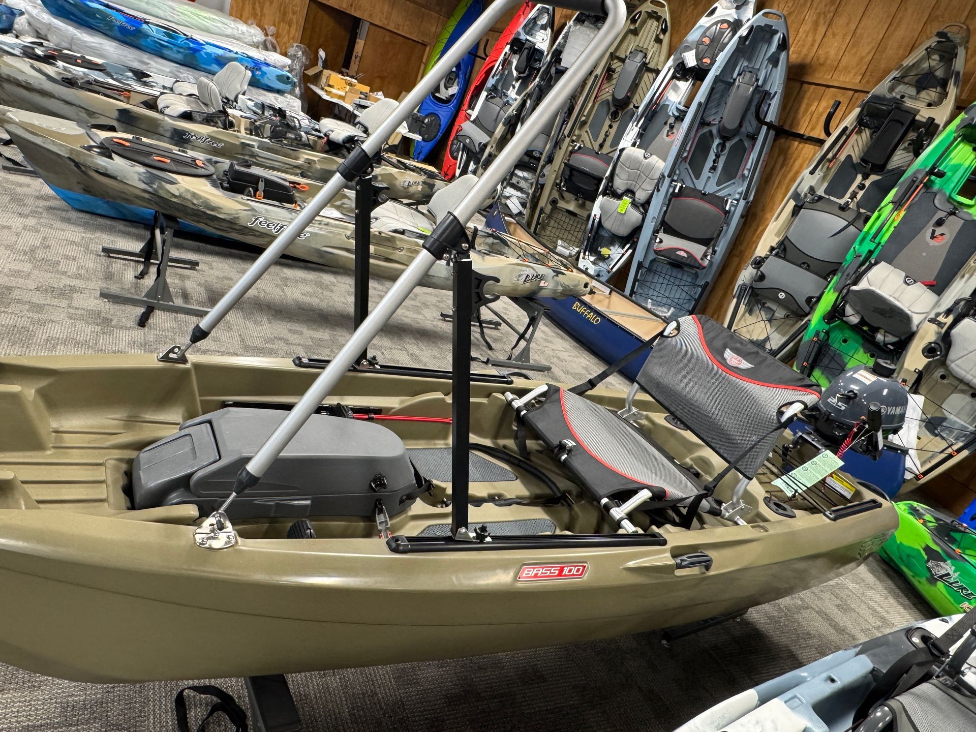 A row of kayaks are lined up in a room.