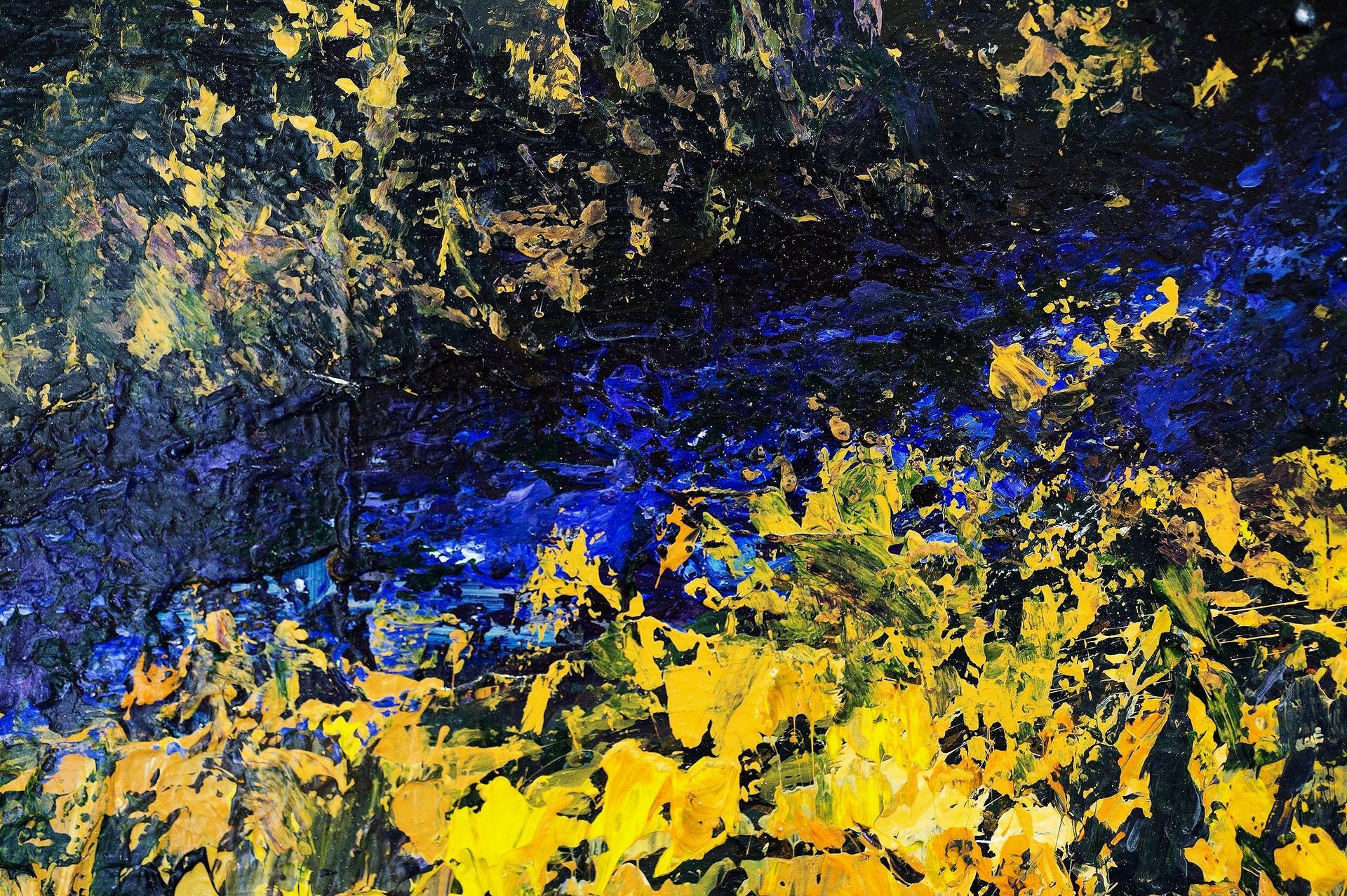 Abstract painting with blue, yellow and black textured paint.