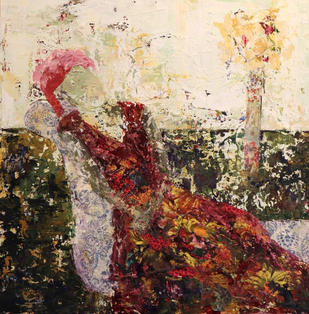 Woman in a floral dress reclines in a patterned chair, holding a red object. Yellow flowers in vase.