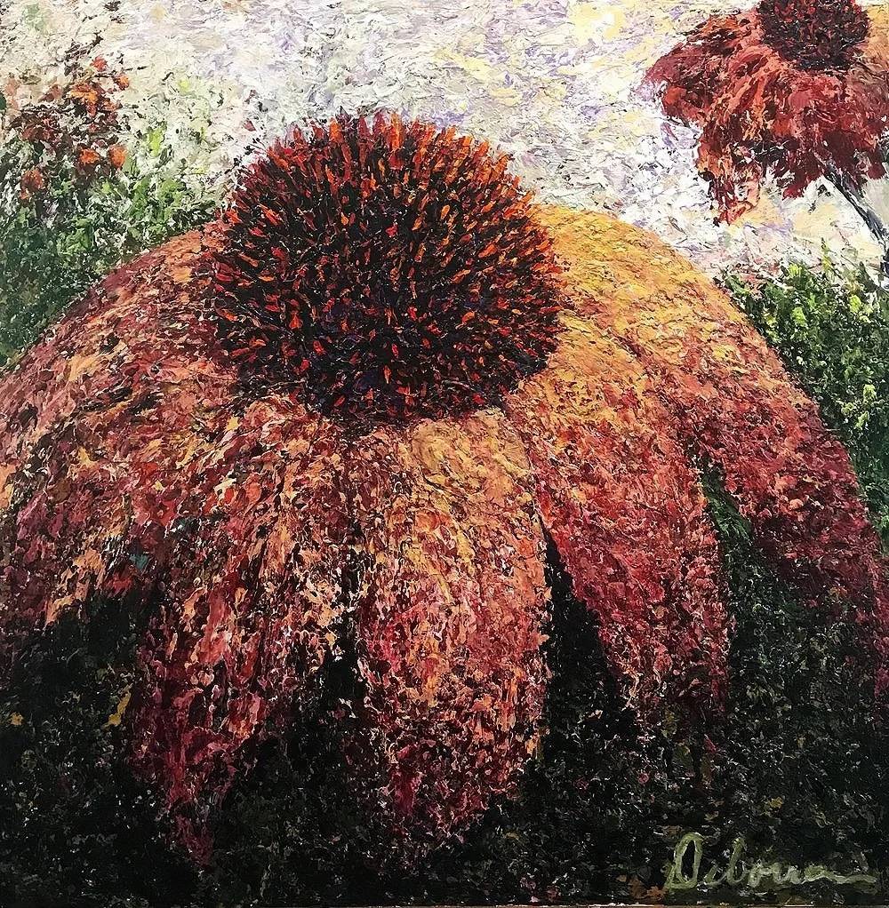 Close-up of a large, brown and orange flower with a textured, impressionistic style. Surrounding greenery and a light sky.