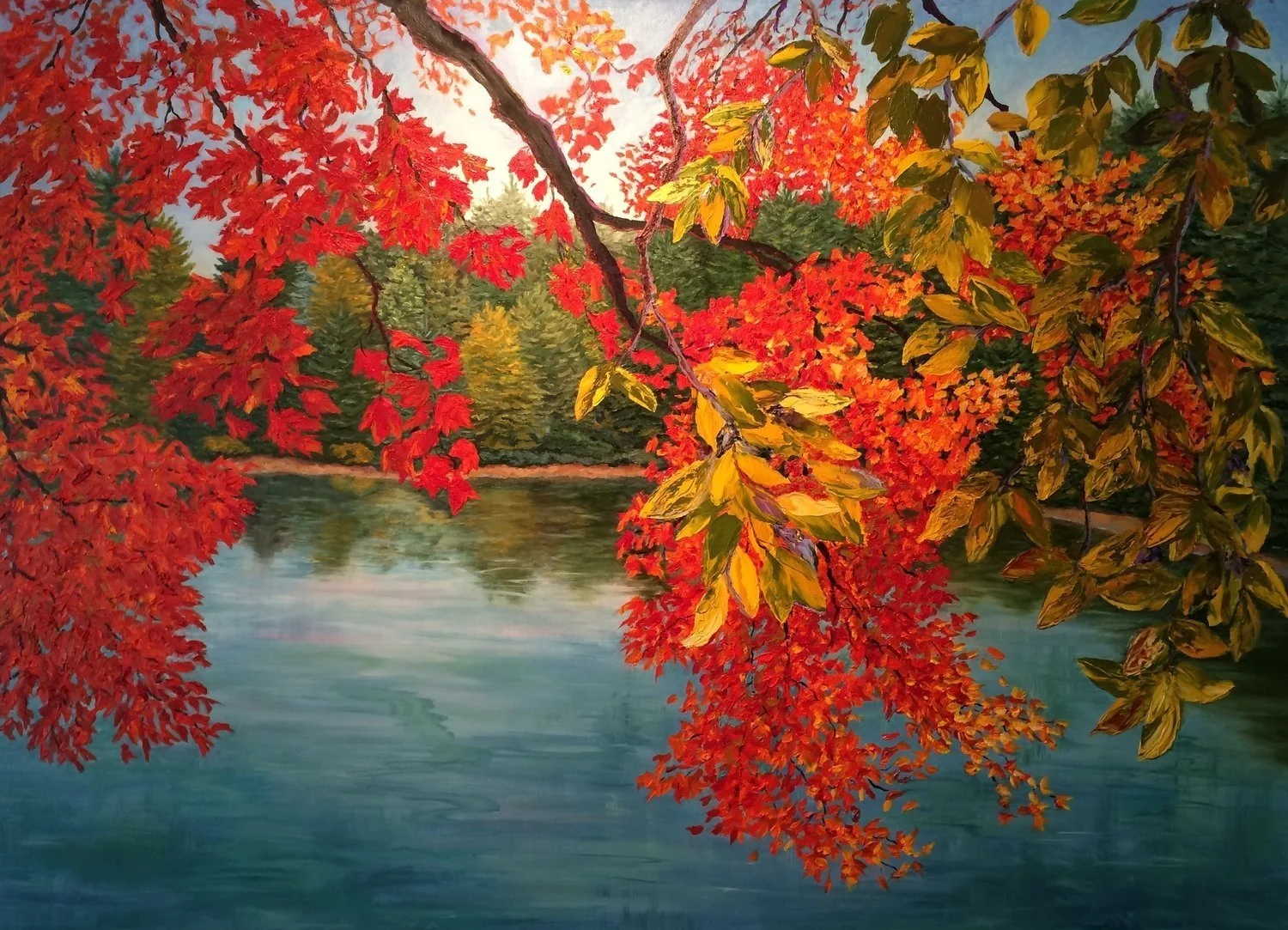 Red and yellow autumn leaves overhanging a calm lake, with trees in the background.