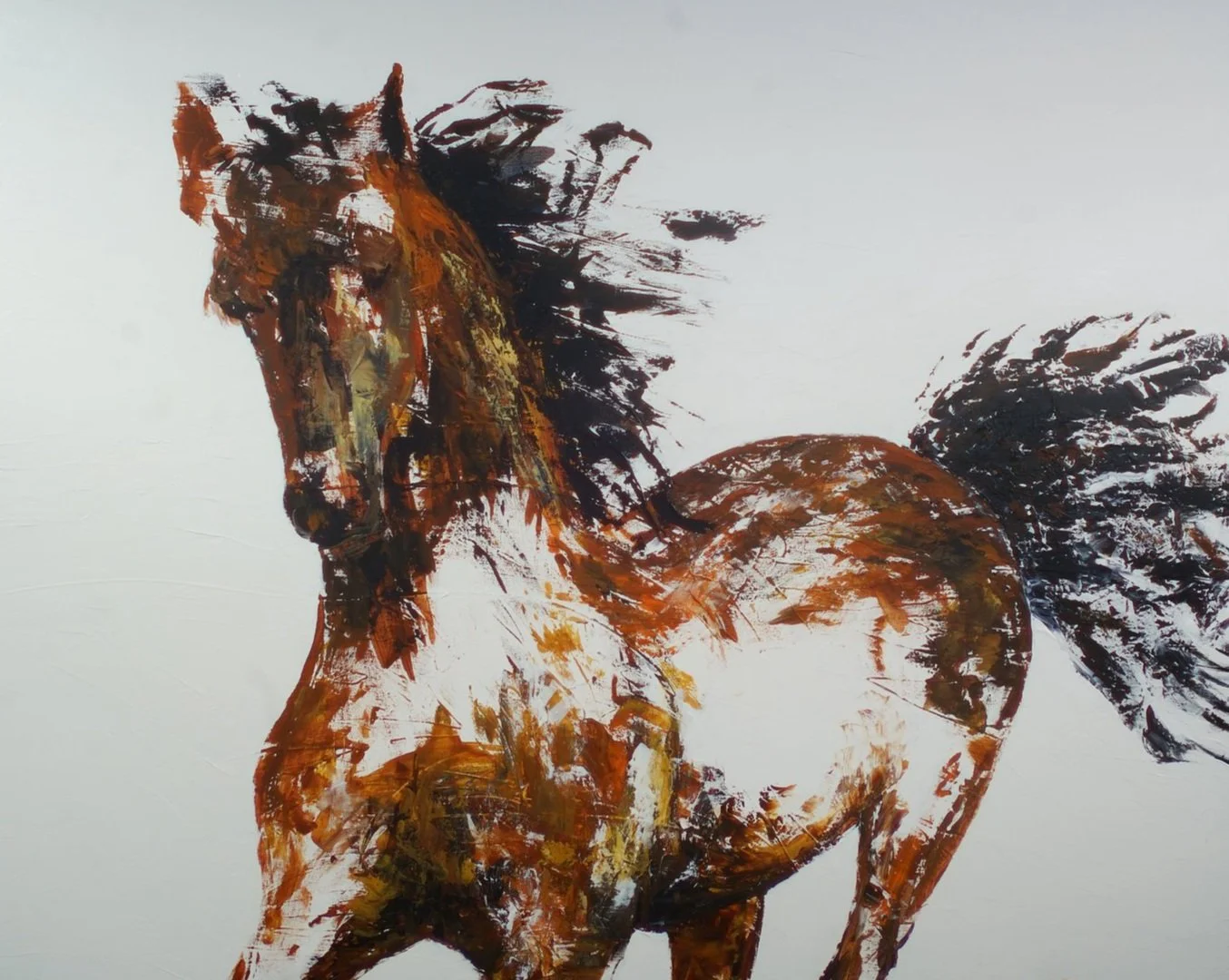 Brown and white horse running with flowing mane and tail, against a white background.