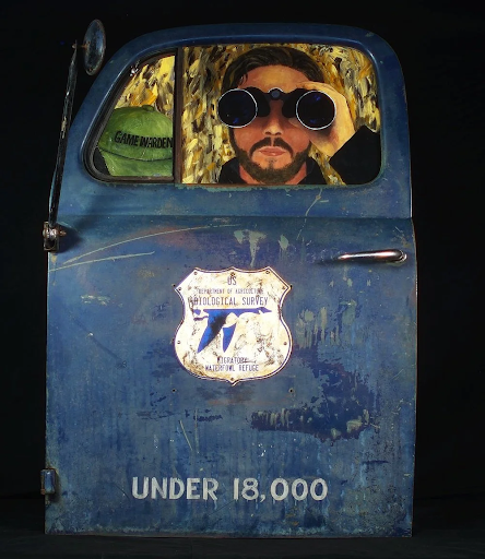 Blue car door with a man looking through binoculars;