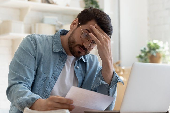 Upset frustrated young man holding reading postal mail letter - Foreclosure attorney in Laredo, TX
