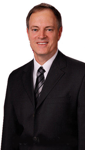 A man in a suit and tie is smiling for the camera.