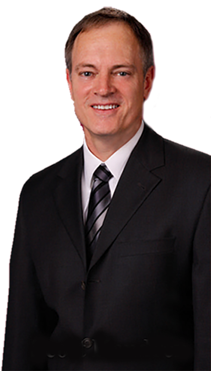 A man in a suit and tie is smiling for the camera.