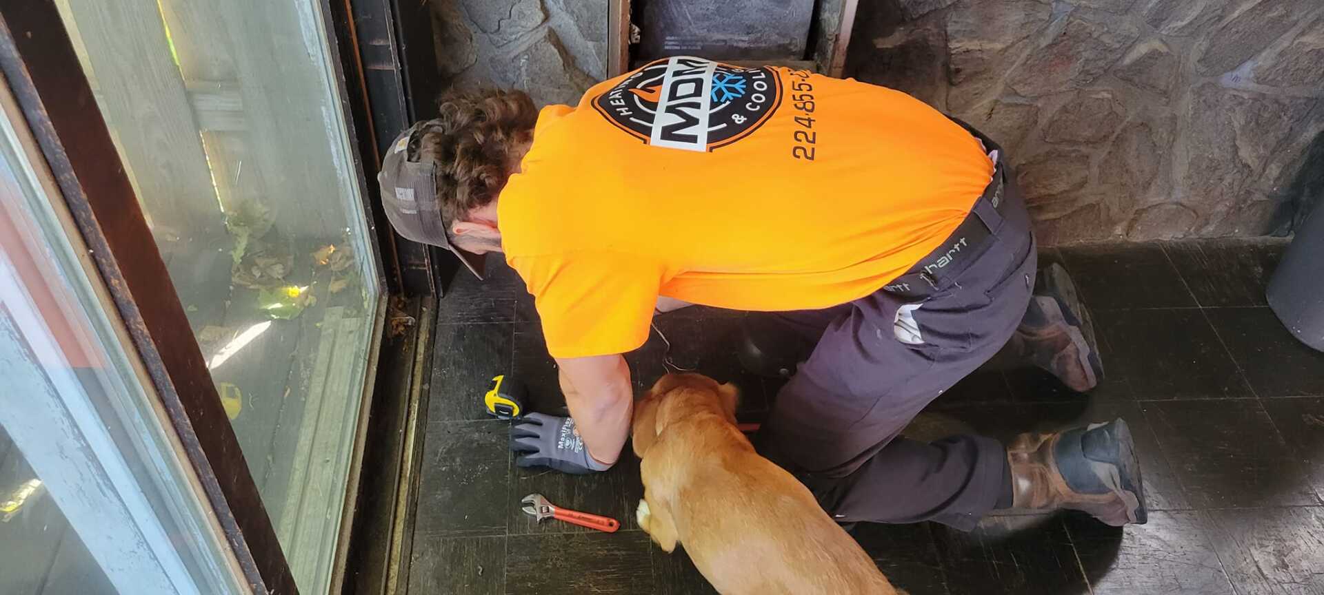 Worker and Dog — Elgin, IL — MDM Heating & Cooling, Inc.