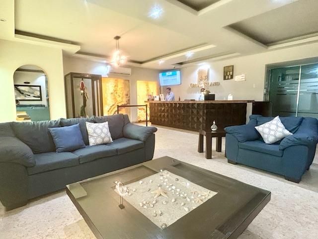 A living room with a couch and chairs and a coffee table