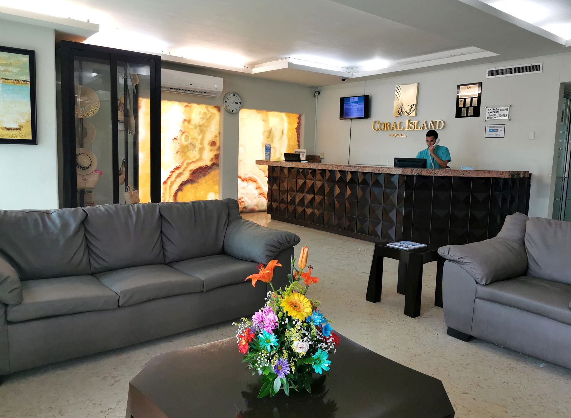 A hotel lobby with a couch and a table with flowers on it