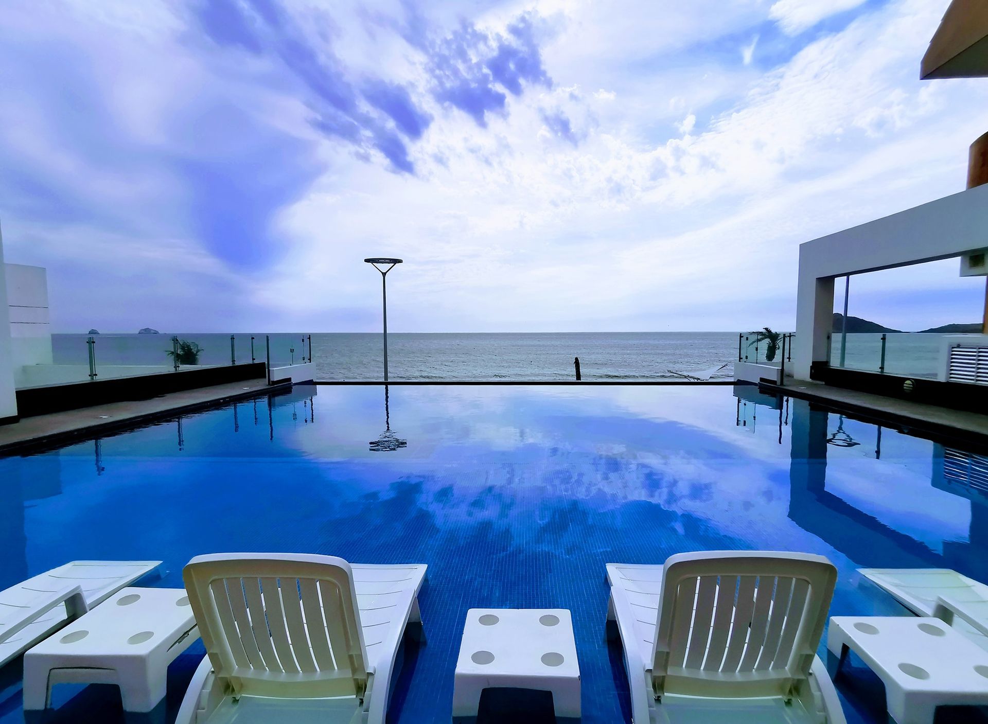 A large swimming pool with a view of the ocean