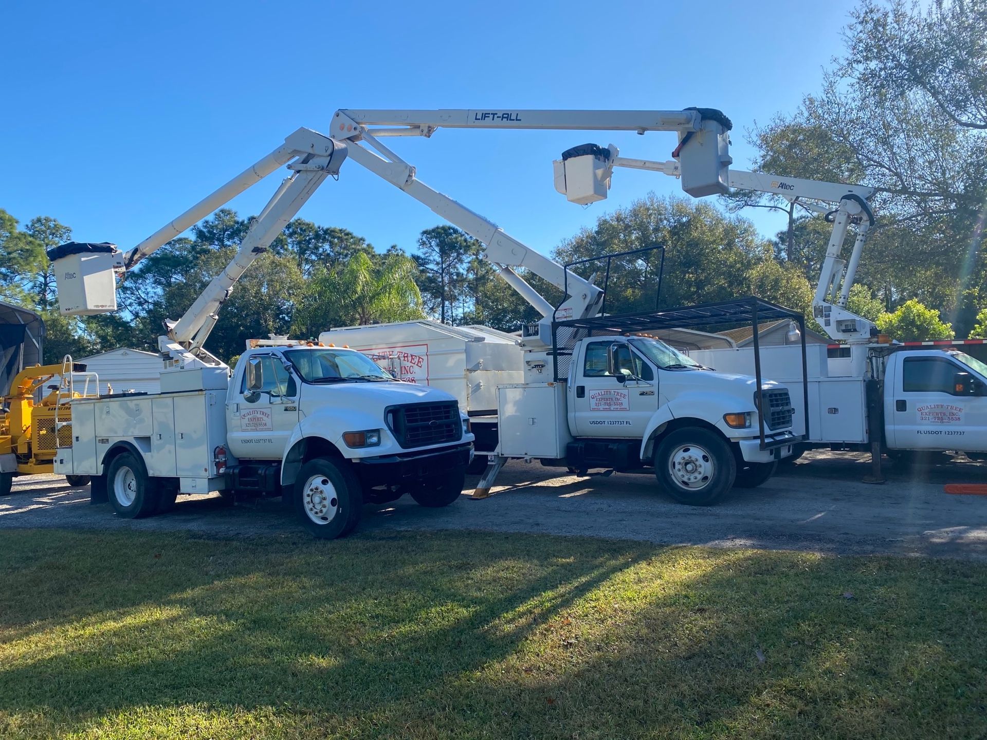 Two White Trucks | Malabar, FL | Quality Tree Experts Inc.