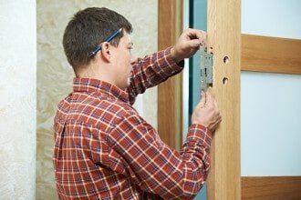 Man fitting door lock - lock company in Philadelphia, PA