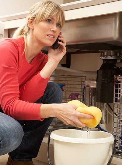 A Woman Calling A Plumber For Water Leak Emergency — Plumber in Allenstown, QLD