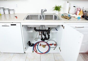 Plumbing Tools Under The Sink — Plumber in Allenstown, QLD