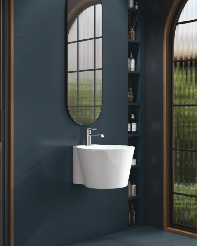 White sink and shelf with copper faucet against dark tile wall.