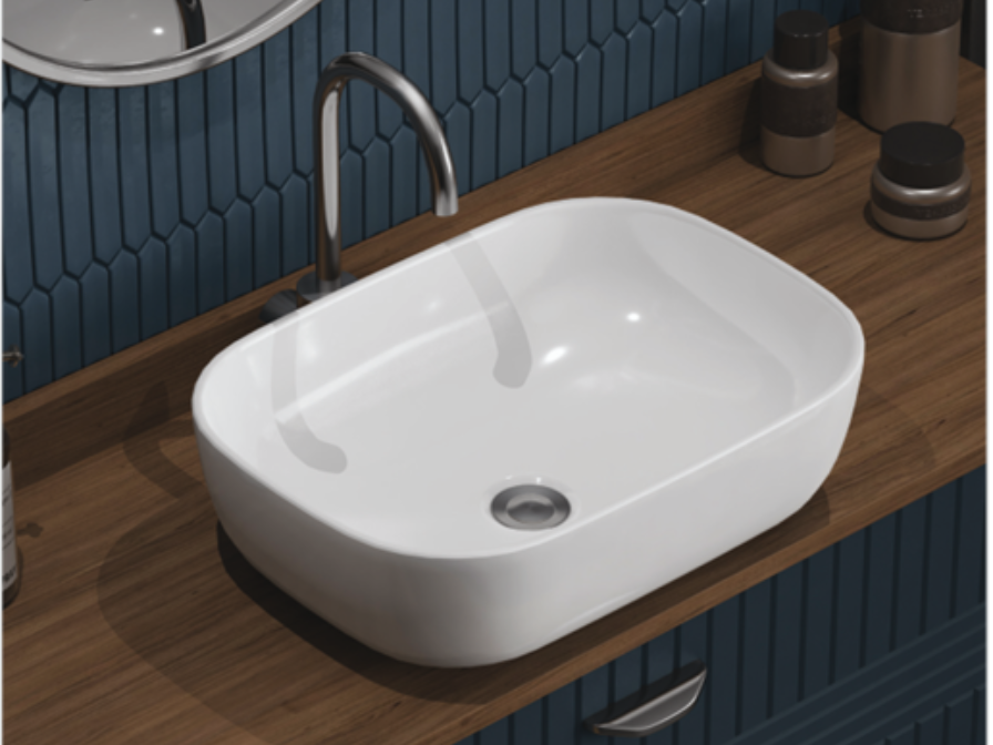 White rectangular vessel sink on a wooden countertop with chrome faucet, bottles, and blue patterned wall.