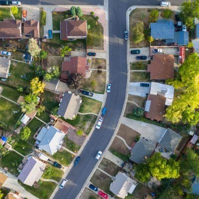An aerial view of a residential neighborhood with lots of houses and trees.