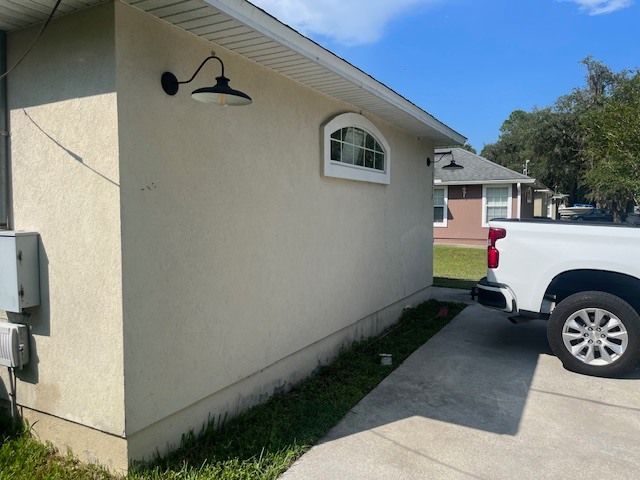 A white truck is parked in front of a house